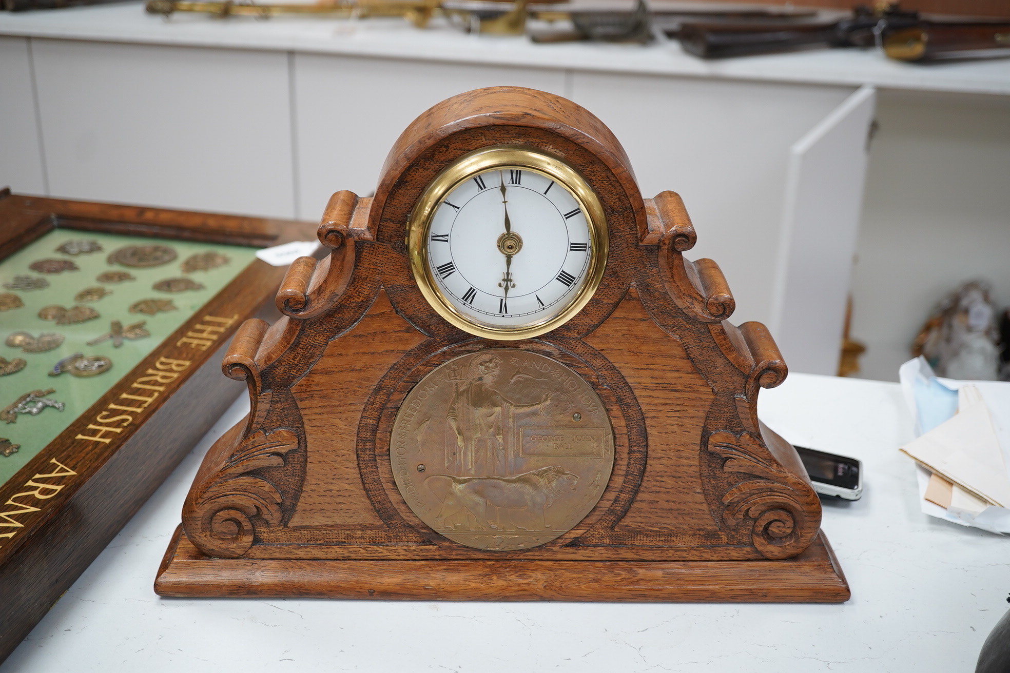 A First World War medal trio awarded to Pte. J. Ball Oxf. & Bucks. L.I., together with an oak mantle clock inset with a memorial plaque awarded to George John Ball, plus related paperwork. Condition - fair to good